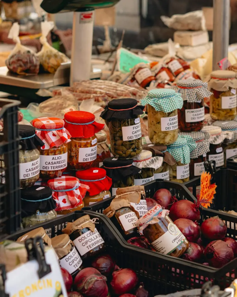 Jars of preserves and cured foods on a market stall