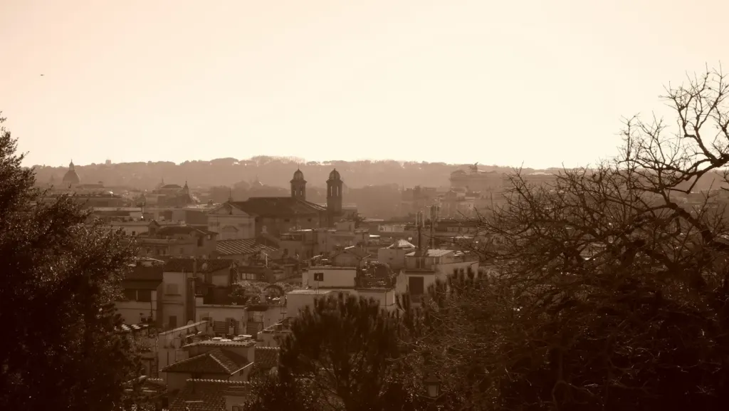 Hazy golden-hour view across the rooftops of Rome