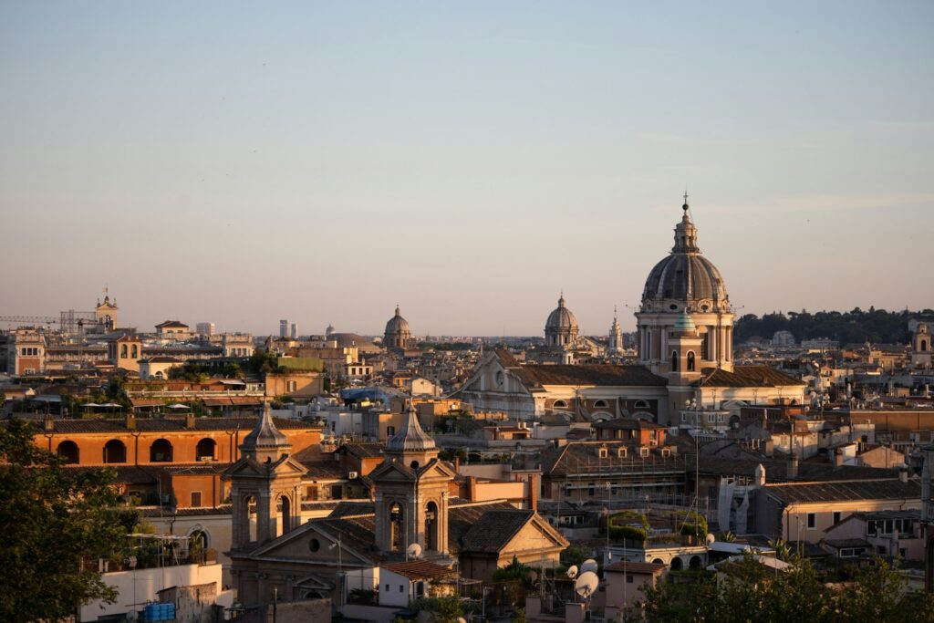 Rome skyline at dusk with the dome of St Peter's and terracotta rooftops