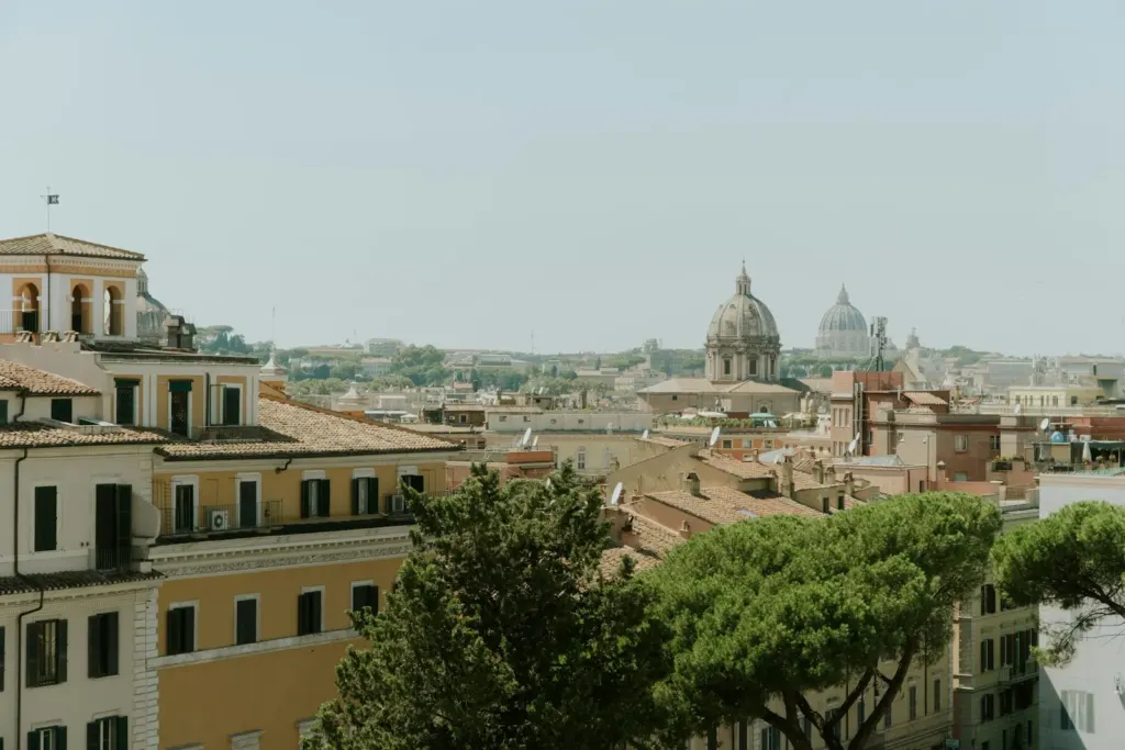 Rome apartment buildings and rooftops with the dome of St Peter's in the distance