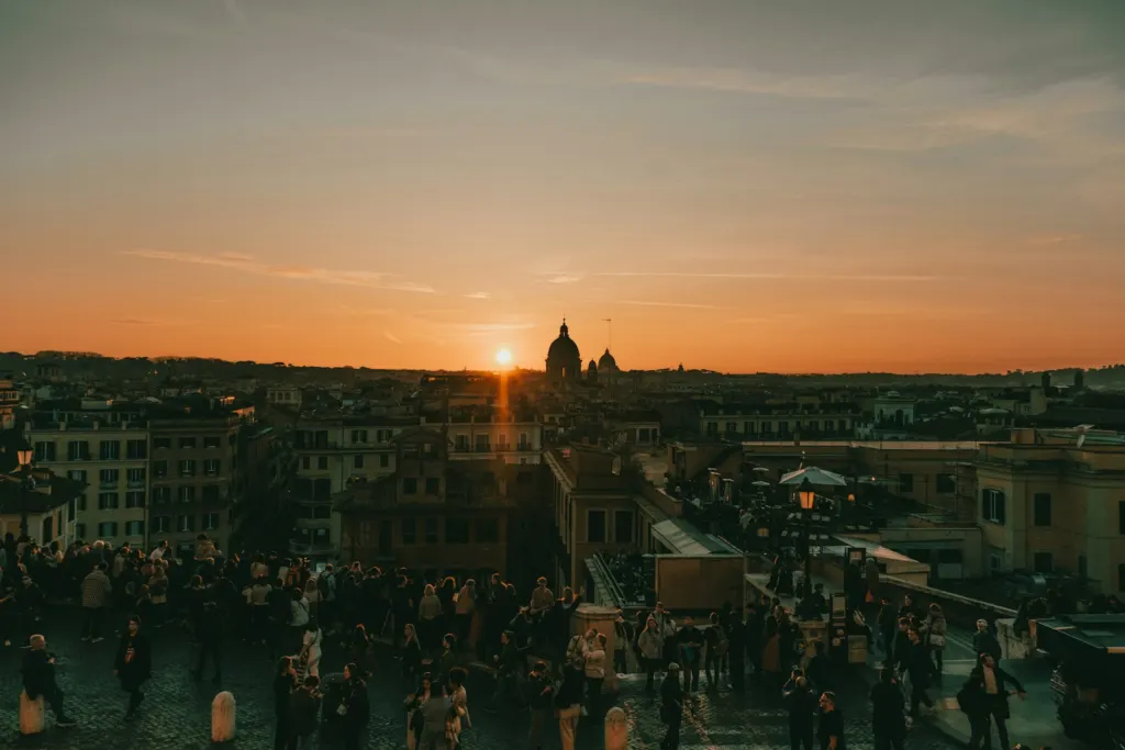 Orange sunset over the rooftops and domes of Rome