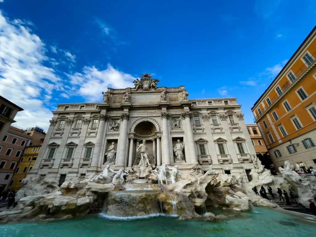 The Trevi Fountain and its baroque facade on a sunny day