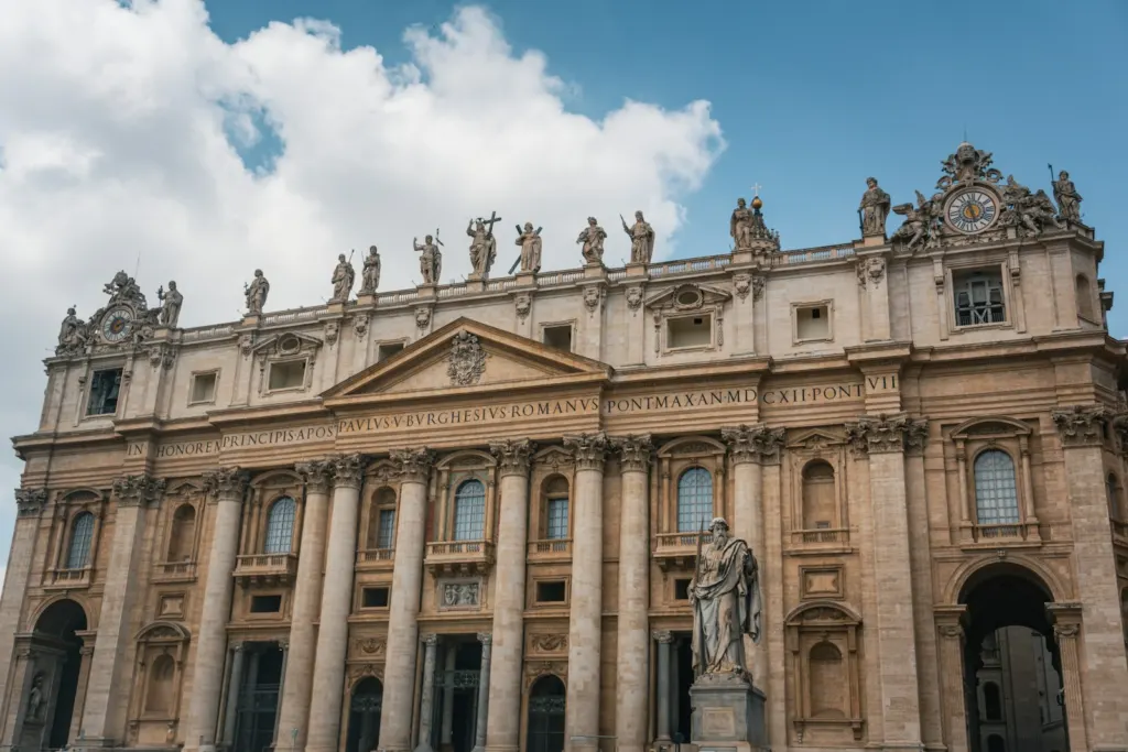 Facade of St Peter’s Basilica with statues against a blue sky